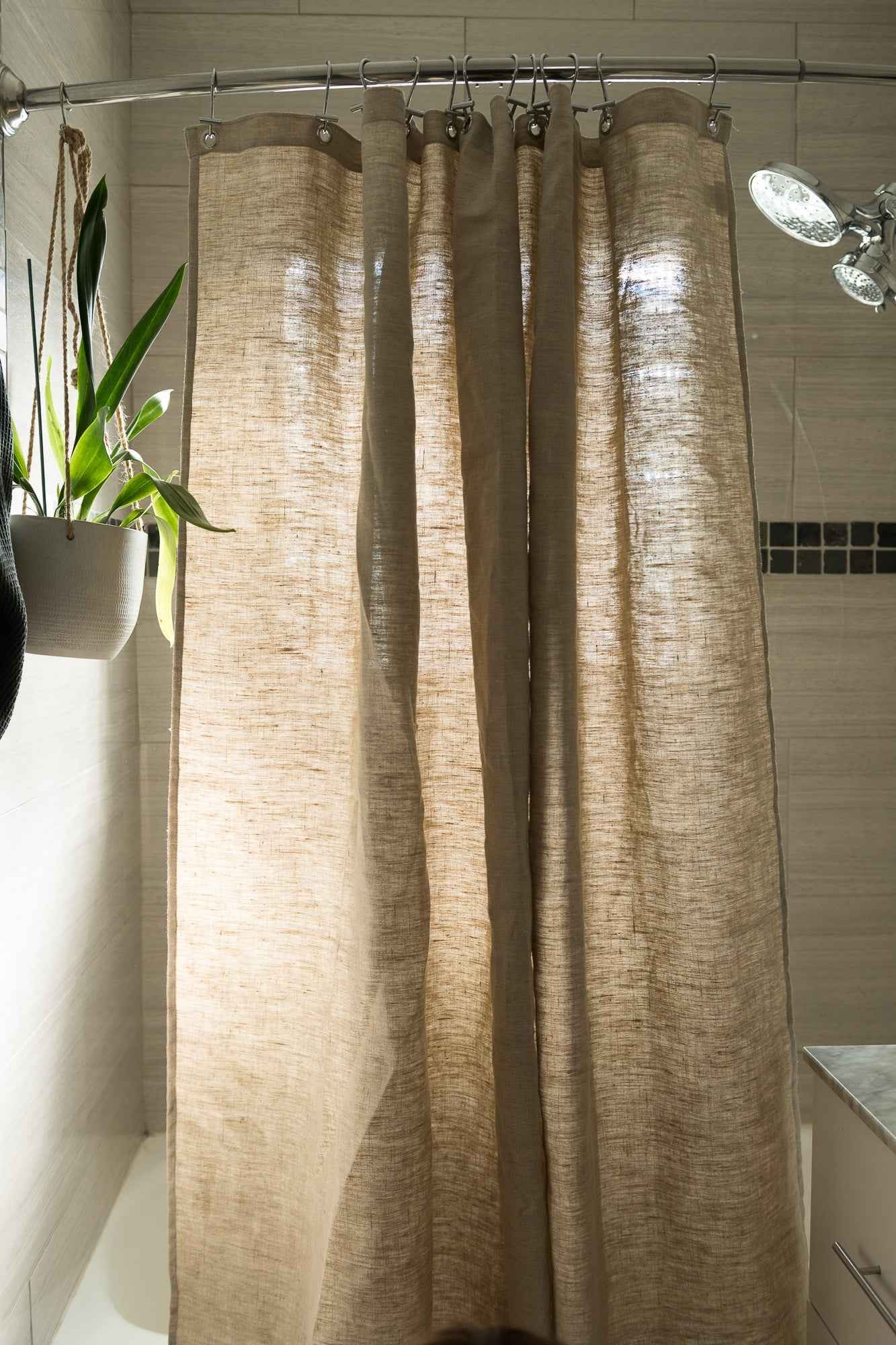 Hemp shower curtain hanging in a bright bathroom